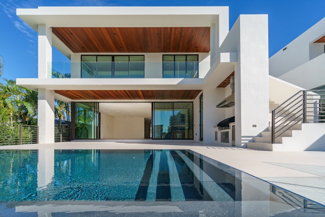 Modern luxury villa exterior with large windows and pool